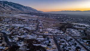 Snowy aerial view with a mountain view and a residential view