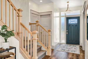 Foyer featuring wood finished floors, stairs, and recessed lighting