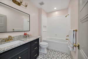 Full bathroom with shower / tub combination, vanity, recessed lighting, and light tile patterned flooring
