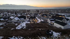 Snowy aerial view with a residential view and a mountain view