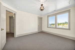 Carpeted spare room with baseboards