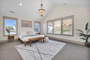 Carpeted bedroom with a chandelier, recessed lighting, and high vaulted ceiling