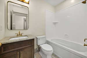 Full bath with vanity and shower / washtub combination