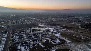 Aerial view at dusk of a mountain view, agricultural area, and a residential view