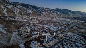 Snowy aerial view with a mountain view and a residential view