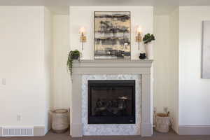 Detailed view of a fireplace and carpet flooring