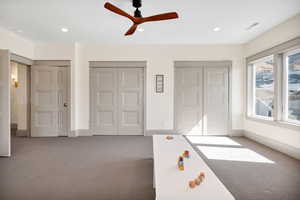 Unfurnished bedroom with multiple closets, carpet, recessed lighting, and a ceiling fan