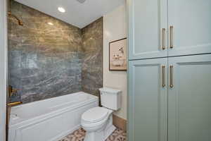Bathroom featuring bathtub / shower combination, recessed lighting, and tile patterned floors