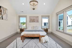 Carpeted bedroom featuring multiple windows, lofted ceiling, recessed lighting, and a chandelier