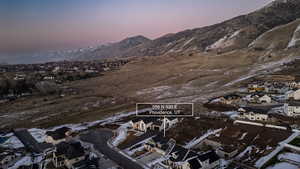 Snowy aerial view with a mountain view and a residential view
