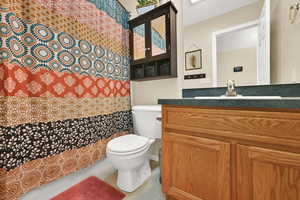 Full bathroom featuring vanity, tile patterned flooring, and shower