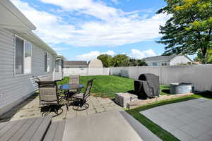 Fenced backyard with a patio area and outdoor dining area