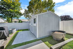 View of shed with a fenced backyard