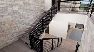Stairs featuring wood finished floors and baseboards
