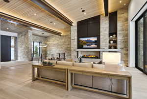 Lobby with high vaulted ceiling and a wooden ceiling with exposed beams