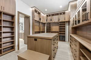 Spacious closet with light wood finished floors