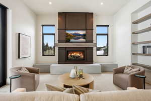 Living room featuring a fireplace, recessed lighting, and healthy amount of natural light