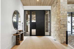 Entrance foyer with wood ceiling and wood finished floors