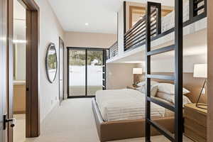 Bedroom featuring wallpapered walls, light colored carpet, access to exterior, recessed lighting, and ensuite bath