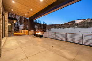 Snow covered patio featuring a patio and a fire pit