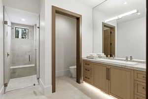 Bathroom featuring a stall shower, vanity, and recessed lighting