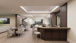 Kitchen with open floor plan, dark countertops, a peninsula, and dark brown cabinets