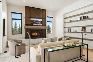 Living room with a large fireplace and recessed lighting