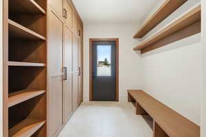 Mudroom with light tile patterned floors