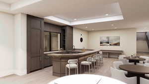 Bar area with open shelves, light wood-style floors, a raised ceiling, and recessed lighting