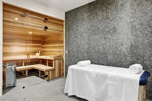 Tiled bedroom featuring a sauna and wooden walls