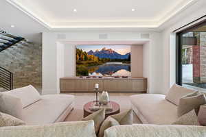 Living area featuring recessed lighting, a tray ceiling, and wood finished floors