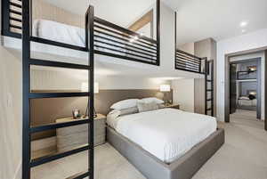 Bedroom featuring wallpapered walls and light colored carpet