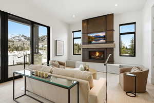 Living room featuring a large fireplace, a mountain view, and recessed lighting