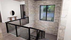 Staircase with wood finished floors and baseboards