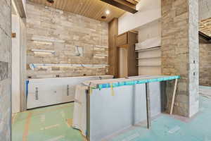 Welcome area featuring a wooden ceiling with exposed beams