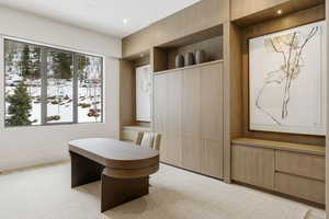 Office with recessed lighting and light colored carpet