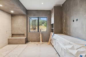 Bathroom with tile walls and recessed lighting