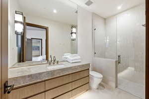 Bathroom featuring vanity, a stall shower, ensuite bath, and light tile patterned floors