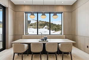 Dining space with plenty of natural light, light wood-type flooring, and a mountain view