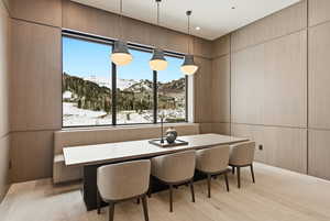 Dining area with a mountain view, light wood-type flooring, and breakfast area