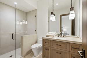 Full bathroom with a shower stall, vanity, and recessed lighting