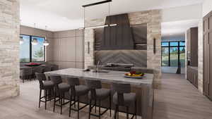 Kitchen featuring pendant lighting, light stone counters, and light wood finished floors