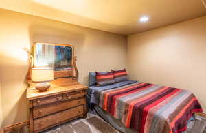 Carpeted bedroom with recessed lighting and baseboards