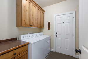 Washroom with cabinet space and separate washer and dryer