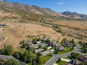 Aerial view of property's location featuring nearby suburban area and a mountain backdrop