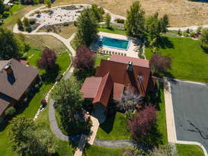Aerial view of property and surrounding area featuring a pool area