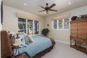 Carpeted bedroom featuring recessed lighting and a ceiling fan