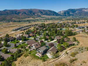 Aerial view of property's location with nearby suburban area and mountains