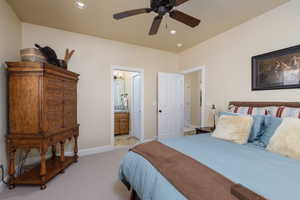 Bedroom featuring recessed lighting, light colored carpet, ceiling fan, and ensuite bath