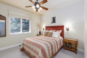 Carpeted bedroom with baseboards and ceiling fan
